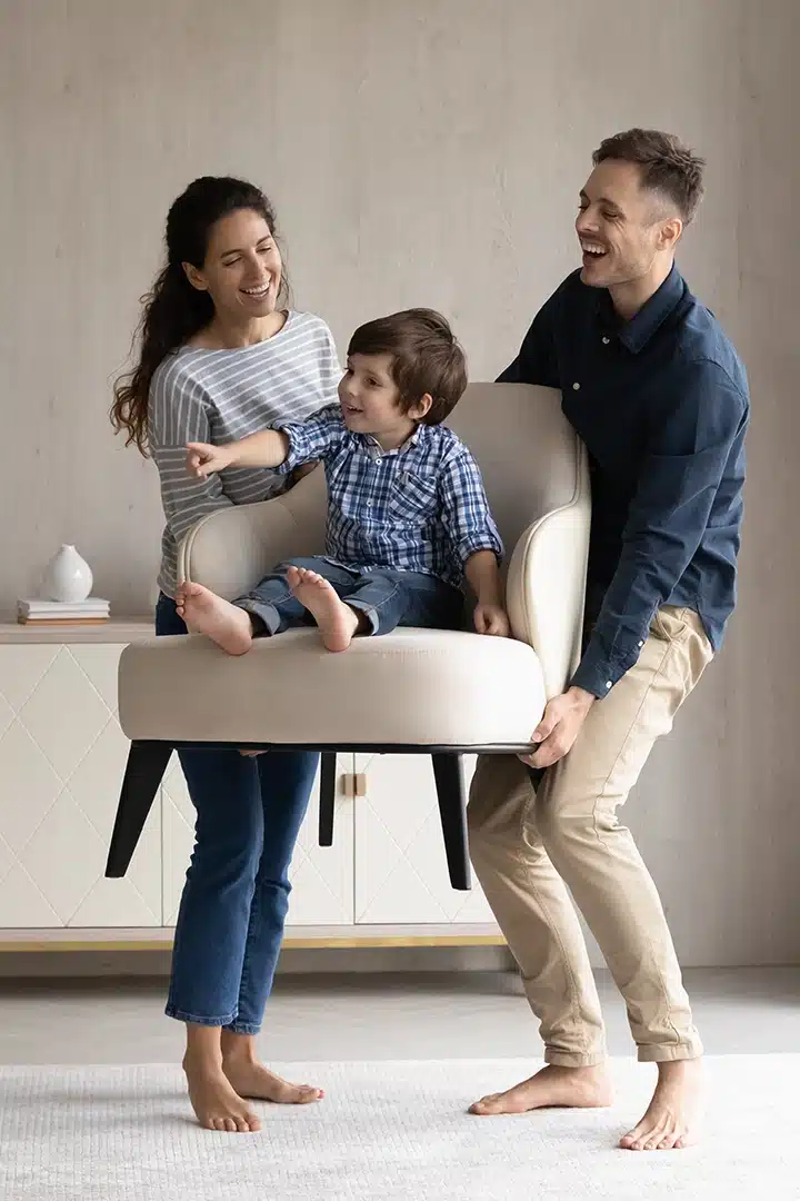 happy family sitting together in their living room, discussing mortgage options with a professional broker